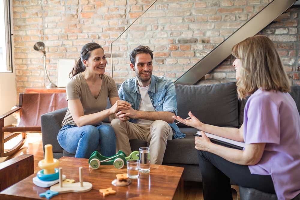 Husband and Wife Talking to Woman with notepad