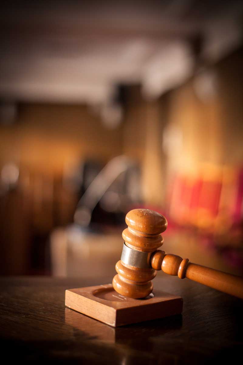 Color image of a hammer in a courtroom.