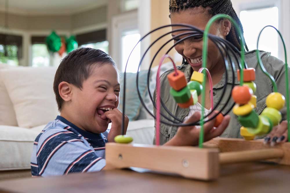 Mom and son playing and laughing with toys