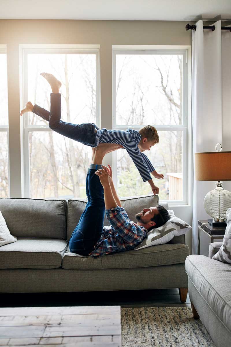 Shot of a father and his little son having fun at home