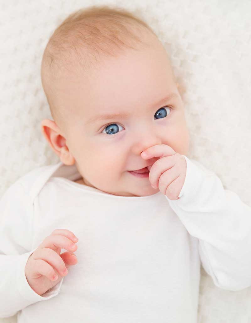 Beautiful Smiling Child Boy in White Clothing