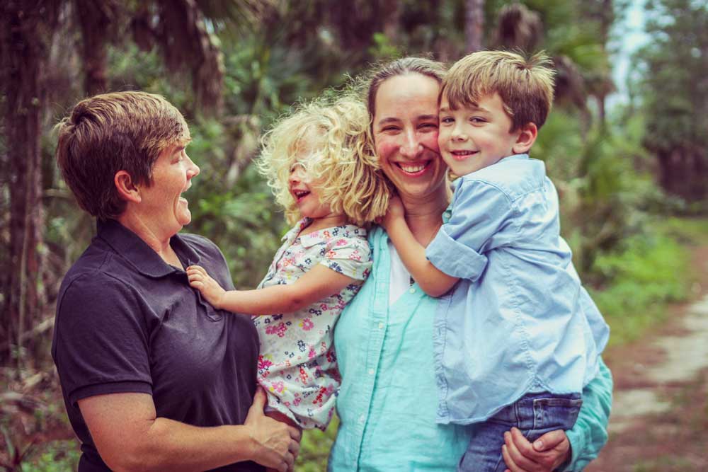 Adorable family, lesbian couple with two small children enjoy time together in the great outdoors