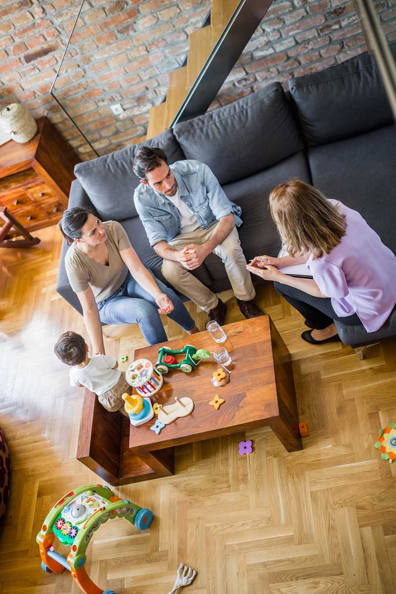 Family with one child on home meeting with a senior female counselor