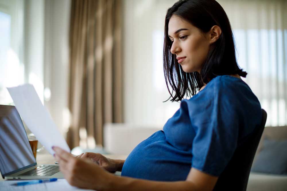 Pregnant woman working at home